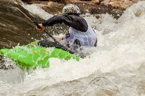 a man in a kayak goes down the cascade river