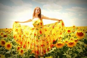 girl in a yellow dress against the backdrop of sunflowers