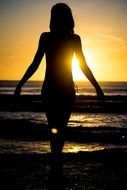 girl near the sea at sunset