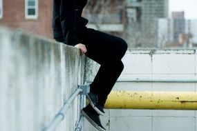 person sitting on wall