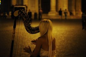 girl with a harp on a city street in monochrome