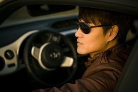 man in sunglasses driving car