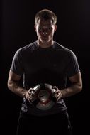 Soccer player is holding the soccer ball