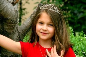 girl in the crown of a princess on a background of nature