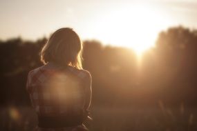 Photo of the girl who is looking at sunset