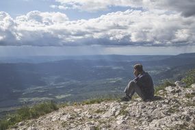landscape of the man is sitting on a mountain