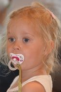 portrait of child girl with pacifier
