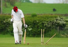 athlete with a bat on a green field