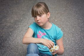 sad girl sitting on the road