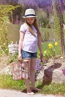 barefoot girl with a luggage