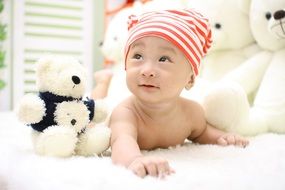 happy baby on the background of teddy bears