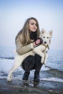 girl with a white puppy of the husky