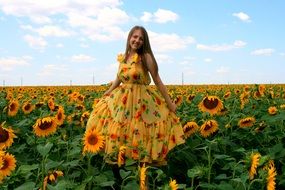 girl in a yellow dress with a pattern of the sunflowers