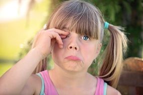 portrait of little girl with on eye closed