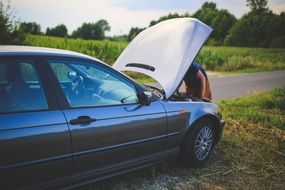 repairing car on the roadside