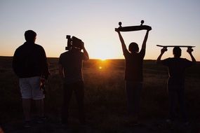 Photo of skateboarders at the sunset