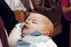 newborn baby sleeping on hands