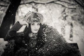 black and white picture of a lady in winter forest