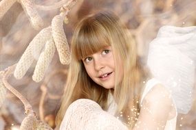 Blonde long haired smiling girl with angels wings