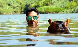 man with hippo in water