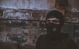 photo of a teenager in a black mask