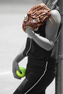 baseball player with a green ball in monochrome image