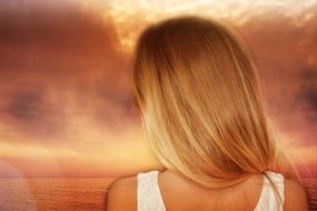 blond long hair girl back view seascape