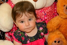 baby near plush toys