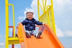 small boy in white hat on playground