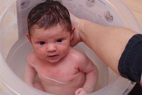 portrait of bathing of a newborn baby