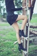 girl climbs a ladder on a tree