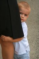the child hid behind an adult