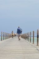 People walking pier sea view