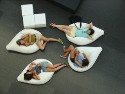 people relaxing on white bag furniture indoor