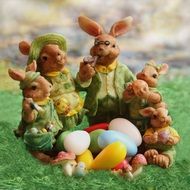 Easter rabbit family figurines with colorful eggs