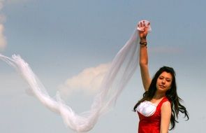 girl posing with a shawl during the wind