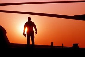 silhouette of a man on a crimson sunset