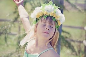 Girl in wreath dancing with closed eyes