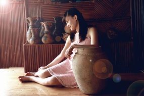 Long haired girl near ceramic vase sunny bungalow