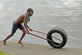boy is playing on a beach in Ghana
