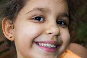 smiling child girl with brown eyes