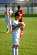 young football man with ball on field