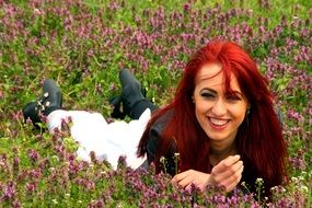 portrait of a girl on a background of grass with flowers