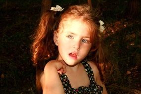 portrait of blue-eyed baby girl with curly hair