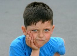 portrait of a boy in a blue t-shirt