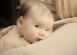 cute baby in the arms of mom