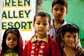 indian children stand near the wall