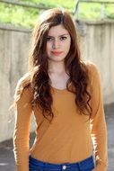 girl with long hair in a sweater and jeans