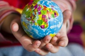 Earth globe in hand