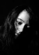 black and white picture shaded of a girl's face with dark hair